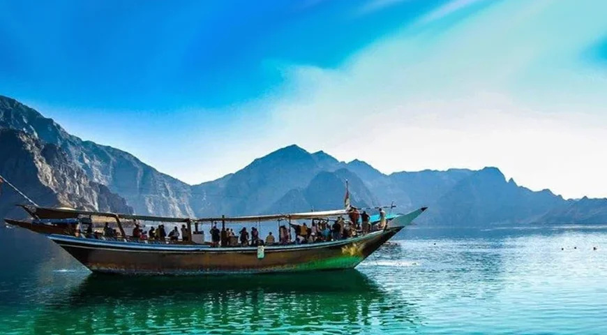 Musandam Dibba Tour from Dubai: Tourists cruising through the fjords of Musandam's natural beauty.