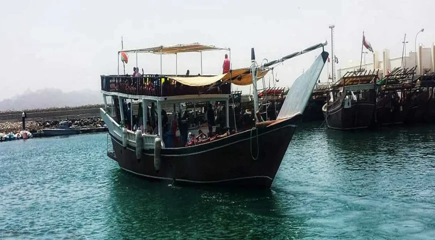 Musandam Dibba Trip from Dubai: A group of tourists enjoying a boat ride through Musandam's clear waters.
