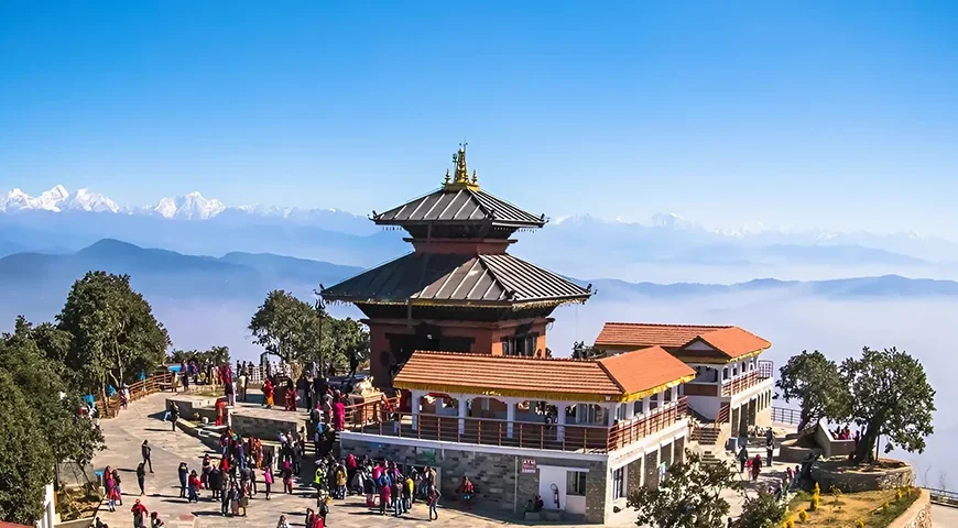 Historic temple in Kathmandu Durbar Square with Himalayas in the background, representing Nepal Tour Packages by Go Kite Travel.